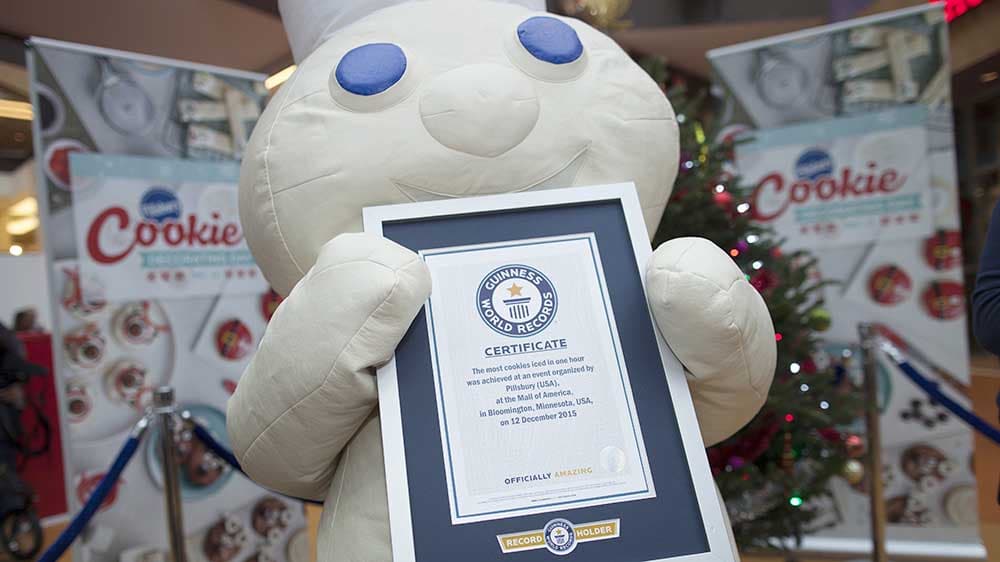 The Pillsbury Doughboy holding an award